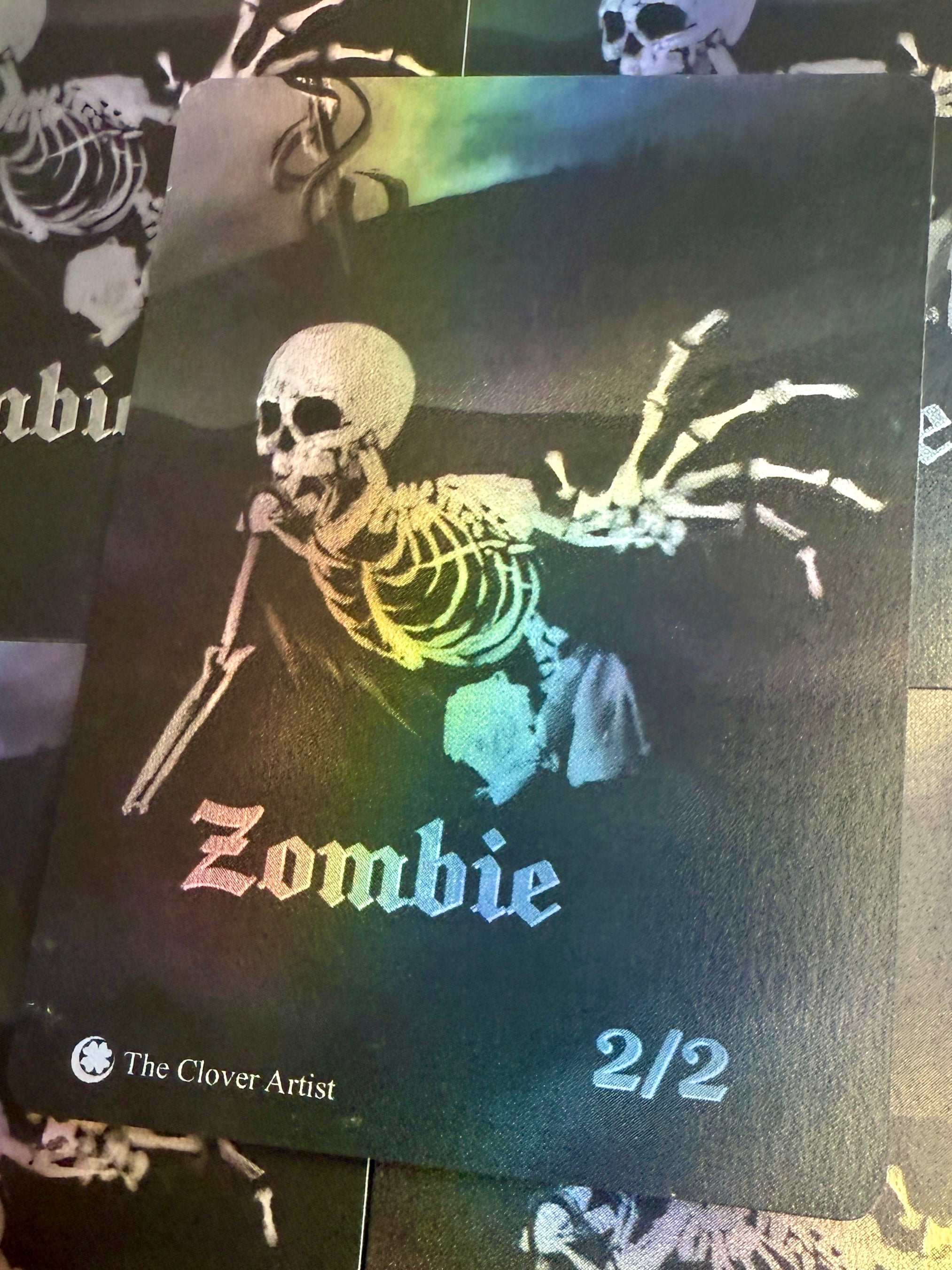 Skeletal design with 'Zombie' text on a dark background, featuring rainbow colors.