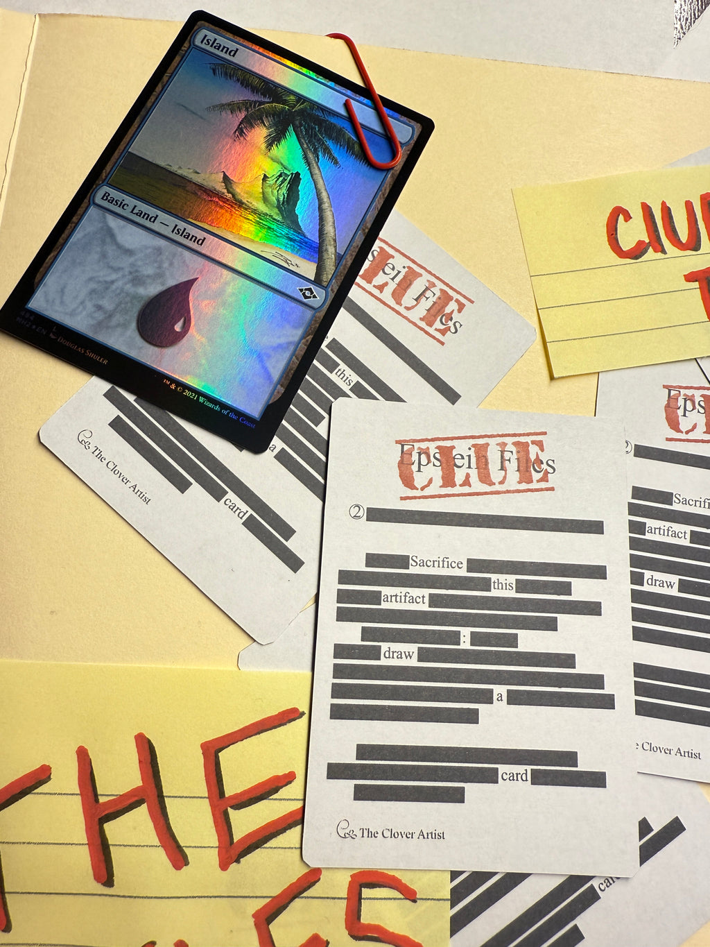 Card with colorful design on a surface with other cards and papers.